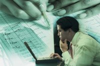 Accountant studying figures on his computer